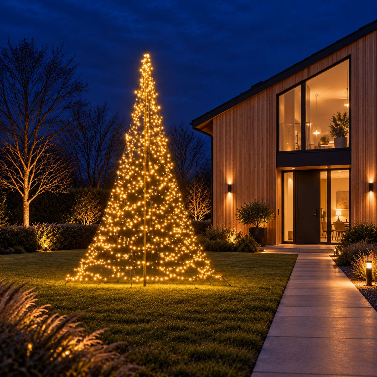 Warm white Fairybell Premium 3 metre on the lawn by the garden path of a timber house with large windows