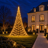 Fairybell Premium 8 metre 3024 LED lit in warm white on the lawn in front of a classic villa at dusk