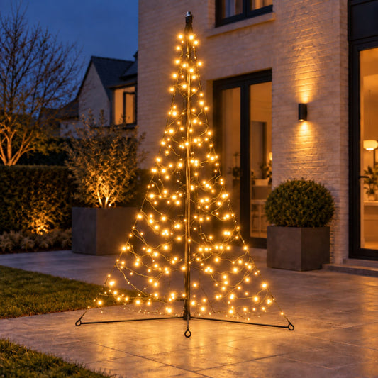 Warm white Fairybell Premium 2 metre All-Surface standing on paving beside topiary balls and a wall light