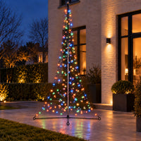 Fairybell Premium All-Surface 3 metre 320 LED in multicolour mode on a patio in front of a brick house in the evening