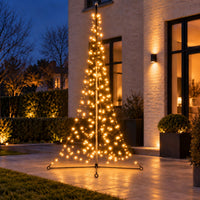 Fairybell Premium All-Surface 3 metre 320 LED lit in warm white on a patio in front of a brick house at dusk