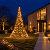 Fairybell Premium 3 metre lit in warm white beside a modern timber house in the evening